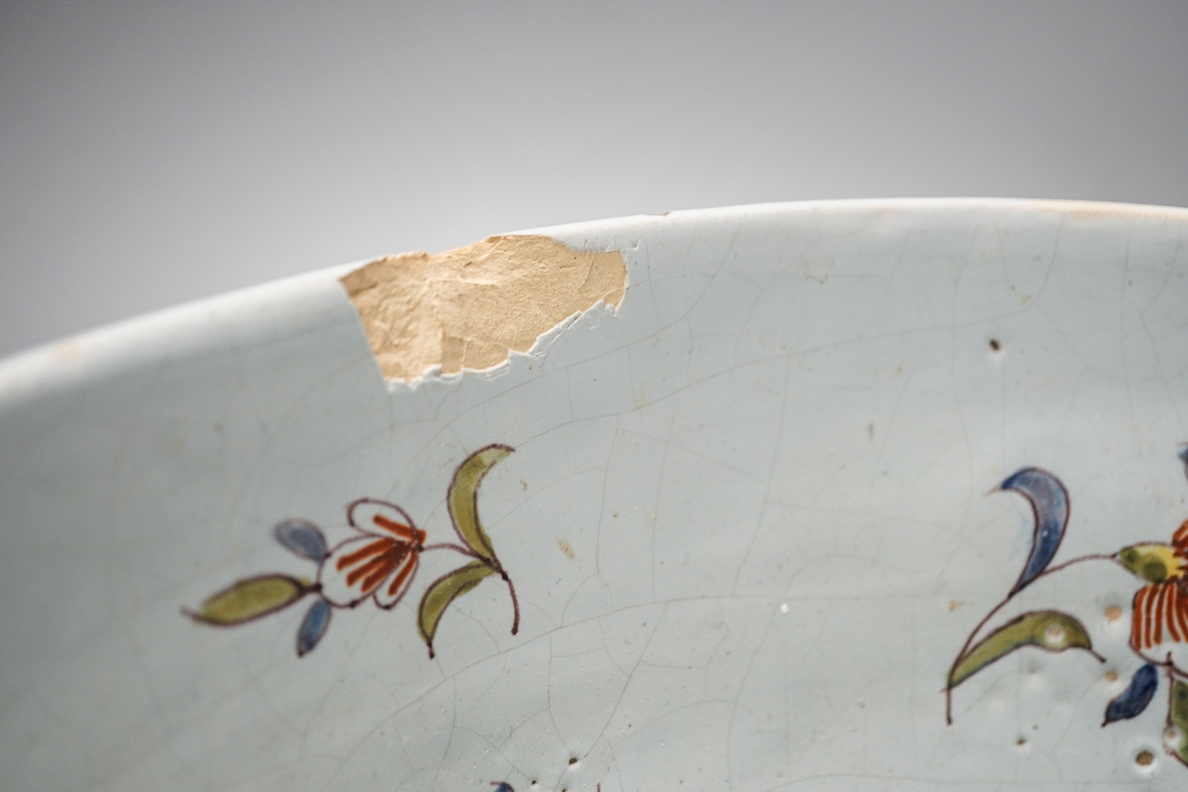Lord Admiral Nelson. A commemorative Delftware punch bowl, 19th century, painted in polychrome with a portrait of Nelson, as hip and floral sprays, D. 30cm, splinter chip to edge